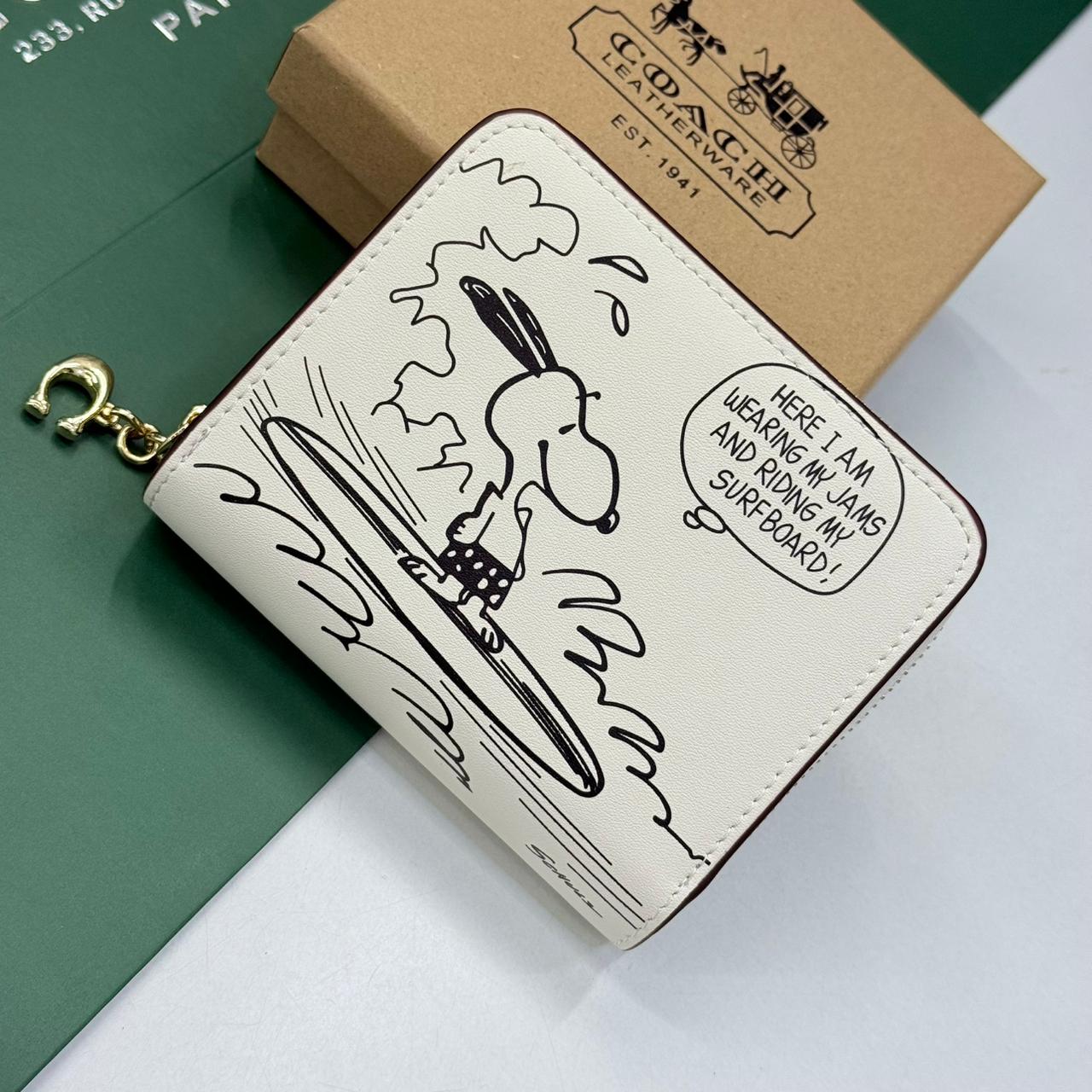WhatsApp Image 2025-10-04 at 6.55.42 PM (1) Coach X Peanuts Essential White Billfold Wallet