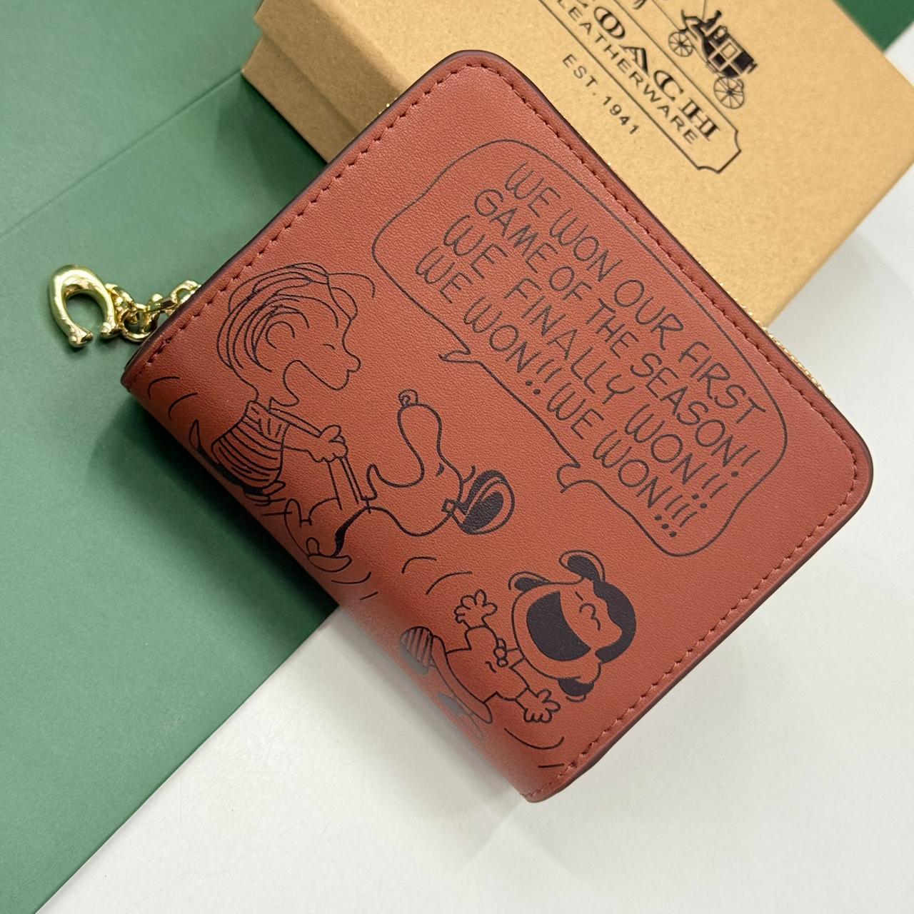 WhatsApp Image 2025-10-04 at 7.03.31 PM (1) Coach X Peanuts Essential Brown Billfold Wallet